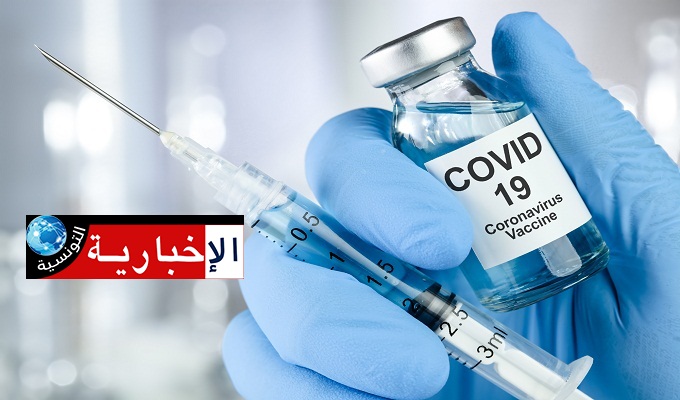 Healthcare cure concept with a hand in blue medical gloves holding Coronavirus, Covid 19 virus, vaccine vial
