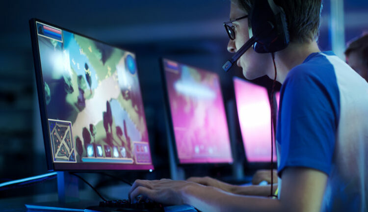 Team of Professional eSport Gamers Playing in Competitive MMORPG/ Strategy Video Game on a Cyber Games Tournament. They Talk to Each other into Microphones. Arena Looks Cool with Neon Lights.